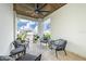 Relaxing covered balcony features tile flooring, ceiling fan, and comfortable seating for outdoor enjoyment at 2501 S Dundee St, Tampa, FL 33629