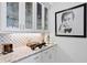 Wet bar with granite countertop, glass cabinets and backsplash at 2501 S Dundee St, Tampa, FL 33629