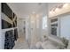 Modern bathroom with a glass-enclosed shower, marble floors, and stylish fixtures and decor at 2501 S Dundee St, Tampa, FL 33629