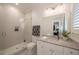 Stylish bathroom featuring a walk-in shower, granite countertop, and modern fixtures at 2501 S Dundee St, Tampa, FL 33629