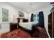 Cozy bedroom featuring a comfortable bed with a striking black headboard and soft lighting at 2501 S Dundee St, Tampa, FL 33629