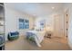 This serene bedroom is complete with a plush bed, a green armchair, and bright sunlight coming through the windows at 2501 S Dundee St, Tampa, FL 33629