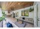 Covered patio features an outdoor kitchen, ceiling fan and comfortable seating with a TV at 2501 S Dundee St, Tampa, FL 33629