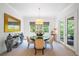 Bright dining room with round table, upholstered chairs, and transom window at 2501 S Dundee St, Tampa, FL 33629