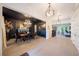 Formal dining room featuring dark accent wall, chandelier, and hardwood floors at 2501 S Dundee St, Tampa, FL 33629