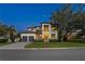 Imposing two-story home with a spacious driveway, lush landscaping, and a basketball hoop at 2501 S Dundee St, Tampa, FL 33629