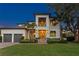 Elegant two-story home with a three-car garage, well-manicured lawn, and beautiful tropical landscaping at 2501 S Dundee St, Tampa, FL 33629