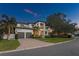 Elegant two-story home with a spacious driveway, lush landscaping, and a basketball hoop at 2501 S Dundee St, Tampa, FL 33629