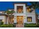 Elegant two-story home with a covered balcony, manicured landscaping, and a welcoming entrance at 2501 S Dundee St, Tampa, FL 33629