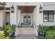 Elegant home entrance with stately planters, exterior lights, and double doors at 2501 S Dundee St, Tampa, FL 33629