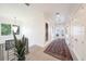 Bright hallway with wood floors, white walls, and a view of the outdoors at 2501 S Dundee St, Tampa, FL 33629
