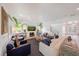 Bright and airy living room with a large sofa, accent chairs, and open staircase at 2501 S Dundee St, Tampa, FL 33629