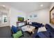 Comfortable living room with a large navy sectional sofa, TV, and a cozy seating area at 2501 S Dundee St, Tampa, FL 33629