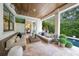 Cozy outdoor patio with plush seating, a wood ceiling, and a TV, perfect for relaxing and entertaining guests at 2501 S Dundee St, Tampa, FL 33629