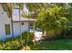 Inviting covered outdoor pool area surrounded by lush tropical landscaping and manicured lawn at 2501 S Dundee St, Tampa, FL 33629