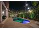 Private backyard pool with elegant lighting and surrounding landscaping creates a relaxing oasis for outdoor enjoyment at 2501 S Dundee St, Tampa, FL 33629
