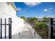 Inviting walkway framed by white stone and lush landscaping leads to waterfront property with boat dock access at 2501 S Dundee St, Tampa, FL 33629