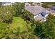Expansive backyard with lush greenery, palm trees, and ample space for outdoor activities and relaxation at 2501 S Dundee St, Tampa, FL 33629