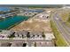 Aerial view of the townhomes shows proximity to the lake, road, and nearby shopping and other neighborhood residences at 2525 Arbor Wind Dr, Lutz, FL 33558