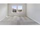 Bedroom featuring plush neutral carpeting and two sunlit windows at 2525 Arbor Wind Dr, Lutz, FL 33558