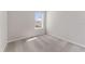 Bright bedroom with a sunlit window and plush neutral carpeting at 2525 Arbor Wind Dr, Lutz, FL 33558