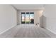Living room with sliding glass doors to the backyard and stairs to the second floor at 2525 Arbor Wind Dr, Lutz, FL 33558