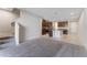 Open-concept living room featuring stairs, plush carpeting, and seamless kitchen access at 2525 Arbor Wind Dr, Lutz, FL 33558