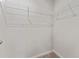Spacious walk-in closet featuring installed white shelving and neutral carpeting at 2525 Arbor Wind Dr, Lutz, FL 33558