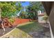 Spacious backyard featuring green space, privacy fence, and mature trees at 2719 Cypress Hollow Ct, New Port Richey, FL 34655