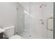 Elegant bathroom features seamless glass shower with marble tile, sleek fixtures, and modern design at 2719 Cypress Hollow Ct, New Port Richey, FL 34655