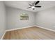 Bedroom with wood-look flooring and ceiling fan at 2719 Cypress Hollow Ct, New Port Richey, FL 34655