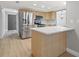Spacious kitchen with stainless steel refrigerator, breakfast bar, and light wood cabinets at 2719 Cypress Hollow Ct, New Port Richey, FL 34655