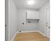 A well-lit laundry room complete with overhead cabinets and utility connections at 2719 Cypress Hollow Ct, New Port Richey, FL 34655