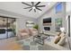 Cozy living room with vaulted ceilings, a fireplace, modern furnishings, and access to a screened patio at 2719 Cypress Hollow Ct, New Port Richey, FL 34655