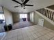 Inviting living room with tile flooring and a large ceiling fan, transitioning to carpet and sliding glass doors at 2751 S Pines Dr # 10, Largo, FL 33771