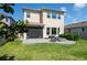 Spacious backyard featuring a well-maintained lawn, patio area, and a fire pit for outdoor enjoyment at 29002 Trevi Pl, Wesley Chapel, FL 33543