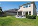 Lush backyard with green grass, patio, and a cozy fire pit, ideal for outdoor gatherings and relaxation at 29002 Trevi Pl, Wesley Chapel, FL 33543
