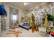 Themed bedroom featuring jungle wallpaper, decorative animals, and a cozy teepee-style bed at 29002 Trevi Pl, Wesley Chapel, FL 33543