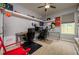 This bedroom with a ceiling fan has built-in shelving and is furnished with two desks and black office chairs at 29002 Trevi Pl, Wesley Chapel, FL 33543