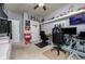 This bedroom with a ceiling fan has built-in shelving and is furnished with two desks and black office chairs at 29002 Trevi Pl, Wesley Chapel, FL 33543