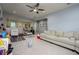 Large, carpeted bonus room featuring a neutral color palette, ceiling fan, and plenty of open space at 29002 Trevi Pl, Wesley Chapel, FL 33543
