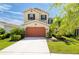 Charming two-story home with a two-car garage and inviting curb appeal, complemented by a well-manicured lawn at 29002 Trevi Pl, Wesley Chapel, FL 33543