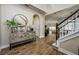 Welcoming foyer with tile floors, decorative console table, staircase and open view to living spaces at 29002 Trevi Pl, Wesley Chapel, FL 33543