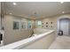 Bright second-floor hallway featuring natural light from multiple windows and views to the living areas below at 29002 Trevi Pl, Wesley Chapel, FL 33543