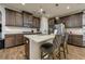 Kitchen featuring stainless steel appliances, granite countertops, and a central island with seating at 29002 Trevi Pl, Wesley Chapel, FL 33543