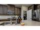 Close-up of kitchen island featuring a stainless steel microwave, cooktop, and stylish countertops at 29002 Trevi Pl, Wesley Chapel, FL 33543