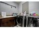 Functional laundry room with modern washer and dryer, sink, countertop space, and ample storage at 29002 Trevi Pl, Wesley Chapel, FL 33543