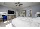 This main bedroom features a tray ceiling, a fan, plush carpet, and plenty of space for a desk at 29002 Trevi Pl, Wesley Chapel, FL 33543