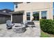 Backyard patio with outdoor furniture and a fire pit, perfect for relaxation and entertaining at 29002 Trevi Pl, Wesley Chapel, FL 33543