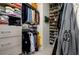 Organized walk-in closet with shelving, hanging rods, and drawers for ample storage of clothing and accessories at 29002 Trevi Pl, Wesley Chapel, FL 33543
